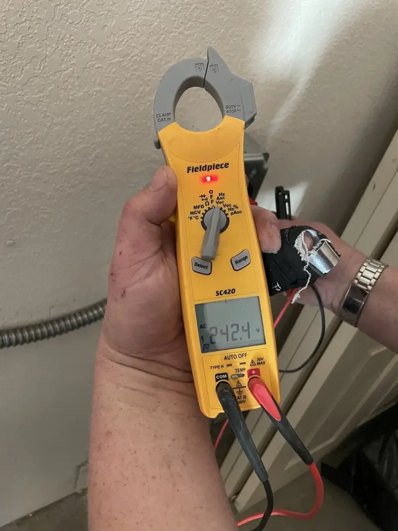 Voltage testing with clamp meter during Ceiling Fan Installation in Airmont